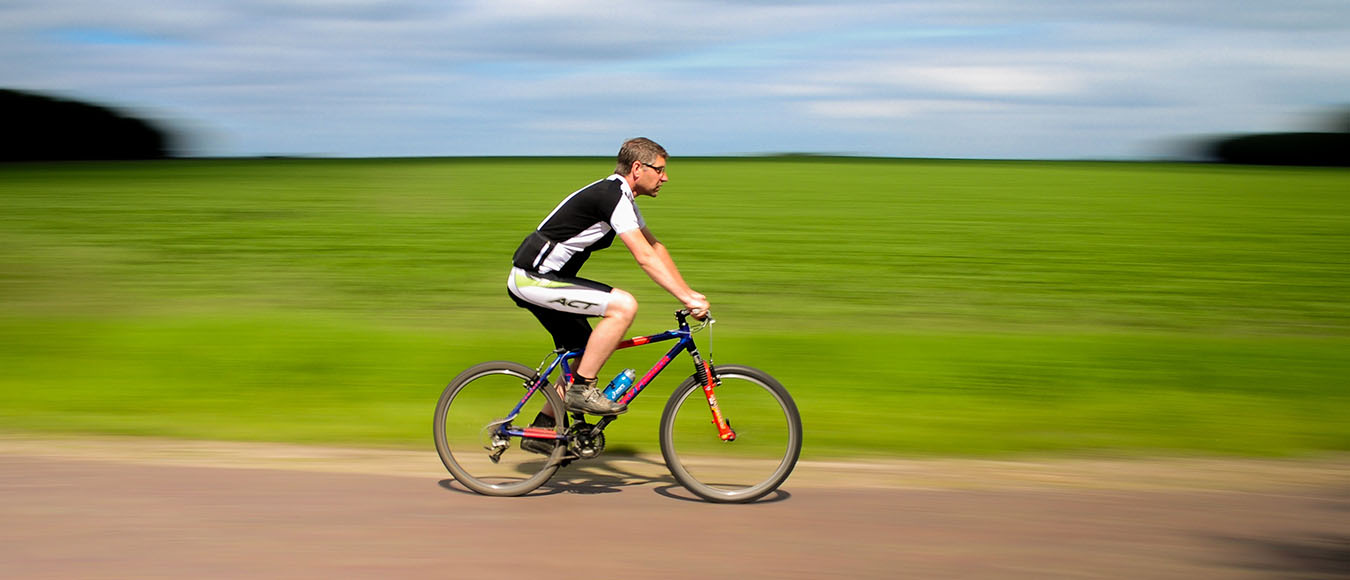 man riding a bicycle blurred background
